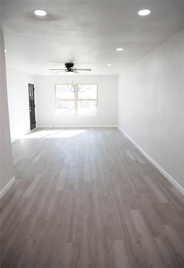 empty room featuring dark hardwood / wood-style floors and ceiling fan