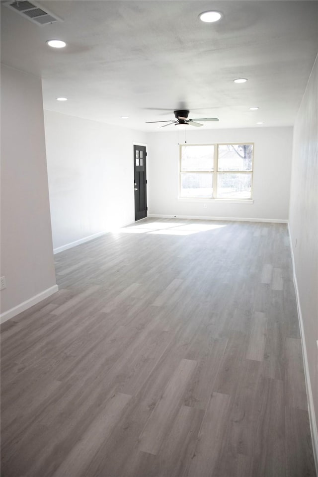 spare room with ceiling fan and wood-type flooring