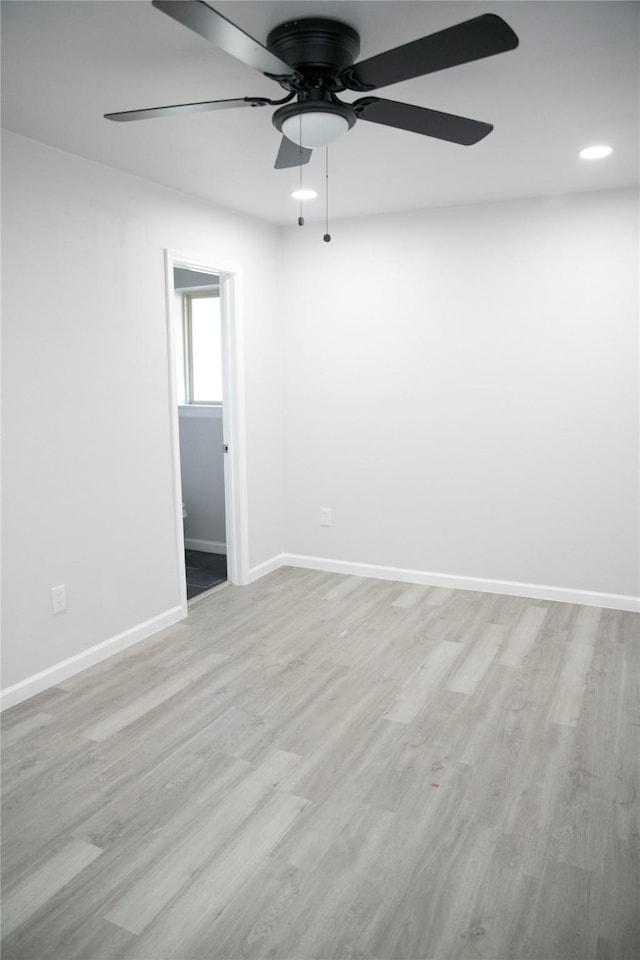 spare room featuring ceiling fan and light hardwood / wood-style floors