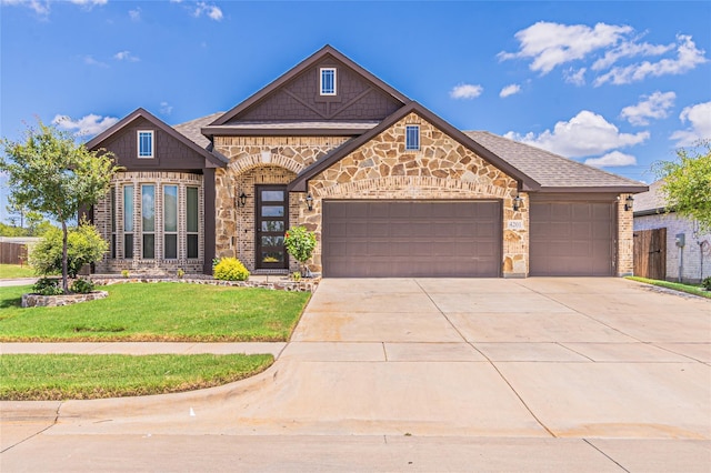 view of front of home with a garage and a front lawn