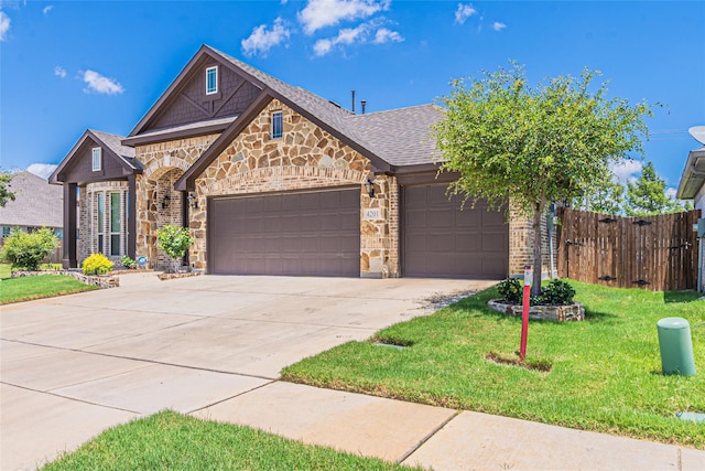 view of front of house featuring a front yard and a garage