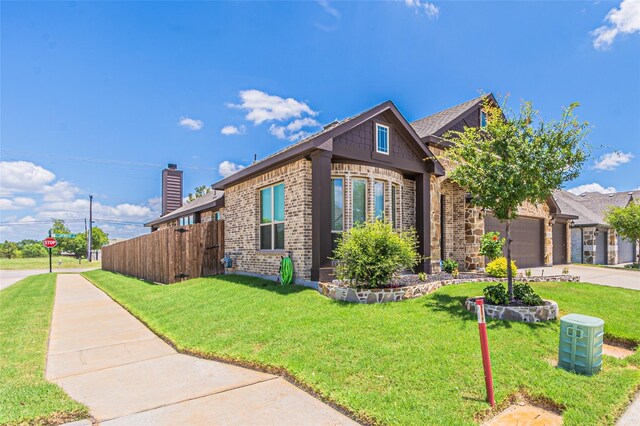 view of front of house featuring a front yard and a garage