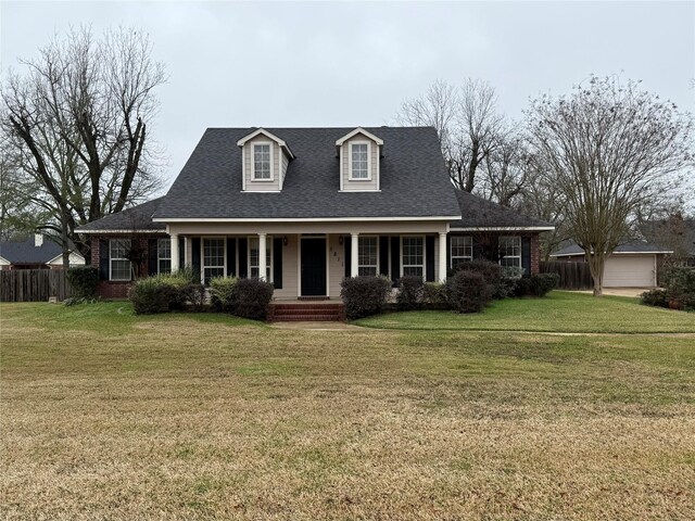 view of front of property with covered porch and a front lawn