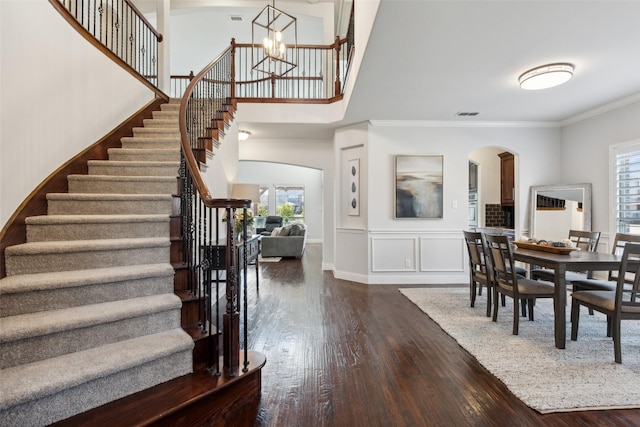 dining room featuring a notable chandelier, dark hardwood / wood-style floors, and ornamental molding