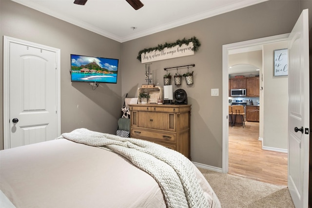 carpeted bedroom with ceiling fan and crown molding