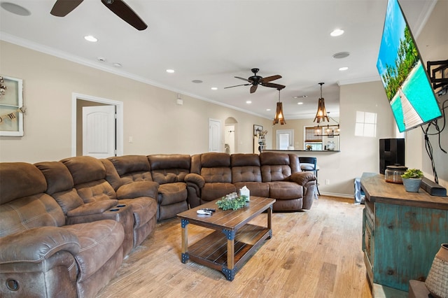 living room featuring ceiling fan, light hardwood / wood-style floors, and ornamental molding