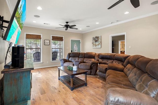 living room featuring light hardwood / wood-style floors and crown molding