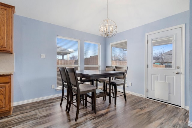 dining room featuring dark hardwood / wood-style flooring and a notable chandelier