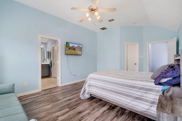 bedroom featuring light wood-type flooring, ensuite bath, ceiling fan, and lofted ceiling