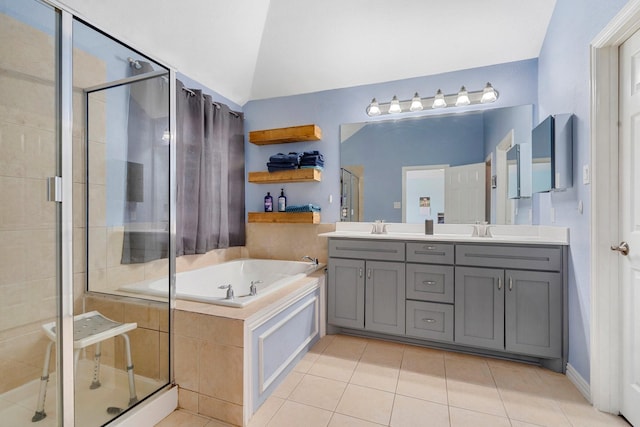 bathroom with tile patterned floors, vanity, plus walk in shower, and vaulted ceiling