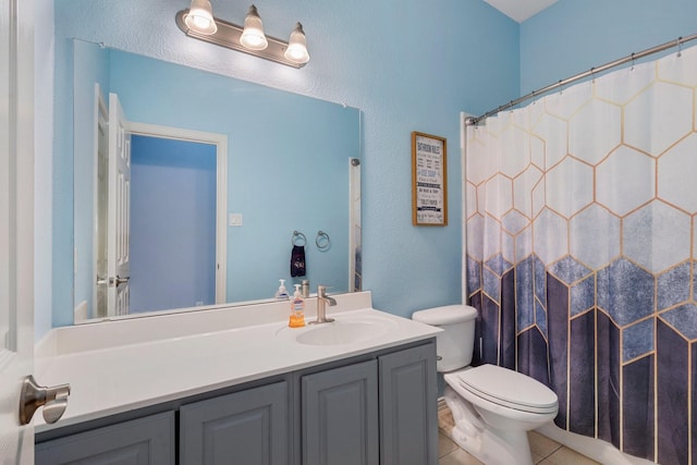 bathroom with walk in shower, tile patterned flooring, vanity, and toilet