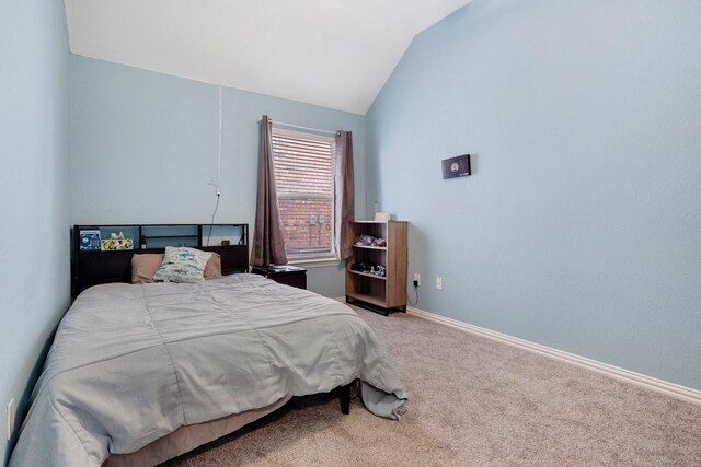 bedroom featuring carpet and vaulted ceiling