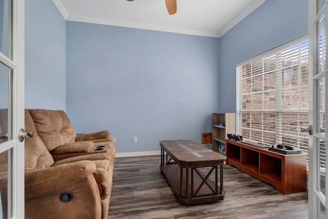 sitting room with french doors, crown molding, ceiling fan, and dark wood-type flooring