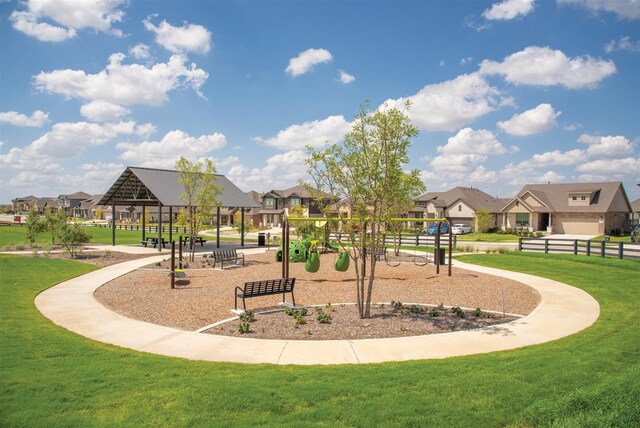 view of property's community with a playground and a yard