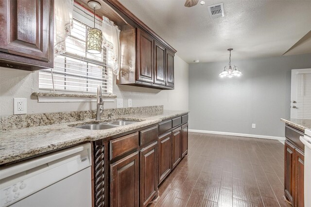 kitchen with dark brown cabinetry, dishwasher, sink, an inviting chandelier, and decorative light fixtures