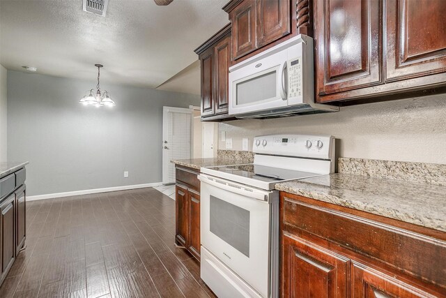 kitchen featuring white appliances, hanging light fixtures, a notable chandelier, dark hardwood / wood-style flooring, and dark brown cabinetry