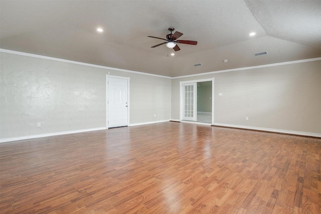 spare room with crown molding, vaulted ceiling, ceiling fan, a textured ceiling, and light hardwood / wood-style floors