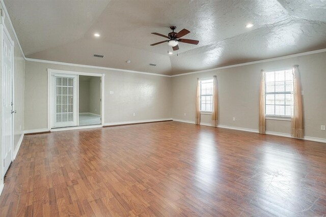 spare room with ornamental molding, a textured ceiling, vaulted ceiling, ceiling fan, and hardwood / wood-style flooring