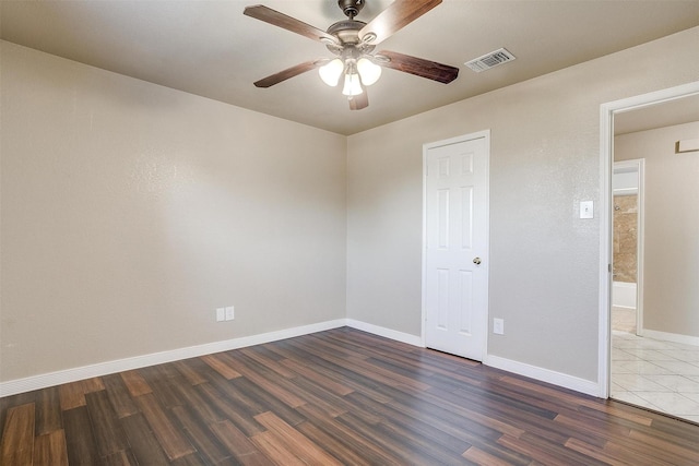 spare room with ceiling fan and dark hardwood / wood-style flooring