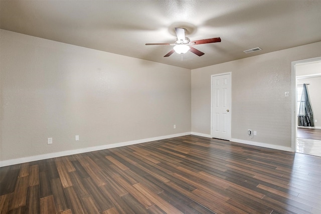 empty room with ceiling fan and dark hardwood / wood-style floors