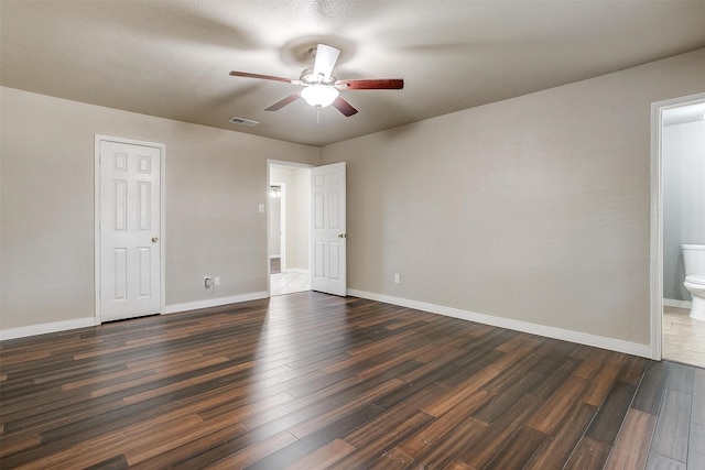 unfurnished room with ceiling fan and dark wood-type flooring