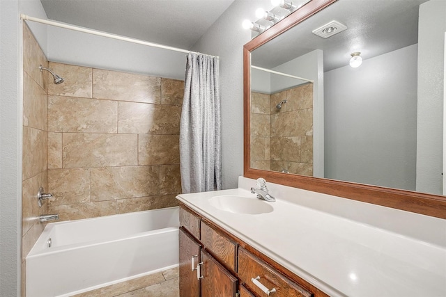 bathroom featuring tile patterned floors, vanity, and shower / bath combo with shower curtain