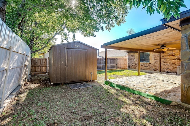 view of yard with ceiling fan, a patio, and a storage unit