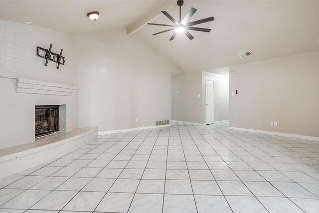 unfurnished living room featuring lofted ceiling with beams, ceiling fan, light tile patterned flooring, and a brick fireplace