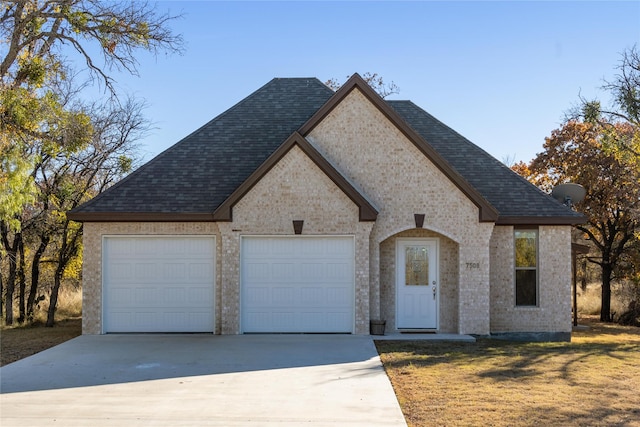 french provincial home with a garage