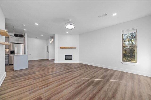 unfurnished living room with dark wood-type flooring