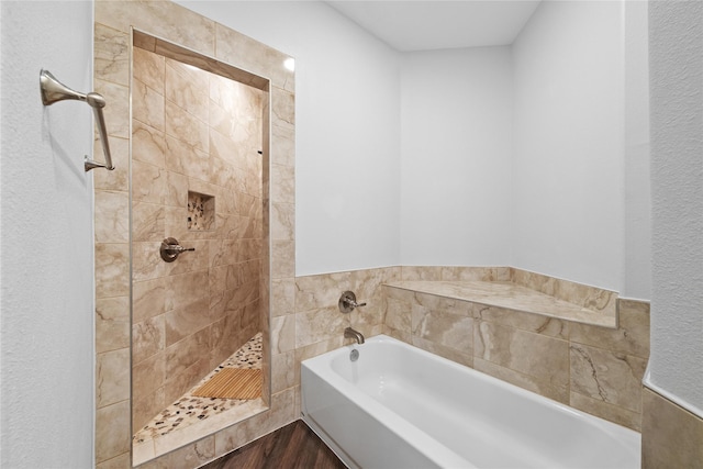 bathroom with hardwood / wood-style flooring and plus walk in shower