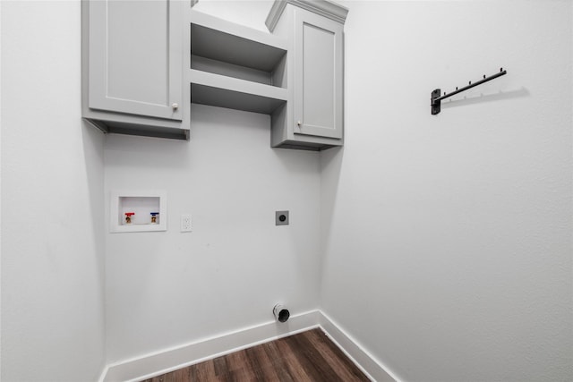 washroom with hookup for an electric dryer, washer hookup, dark hardwood / wood-style flooring, and cabinets