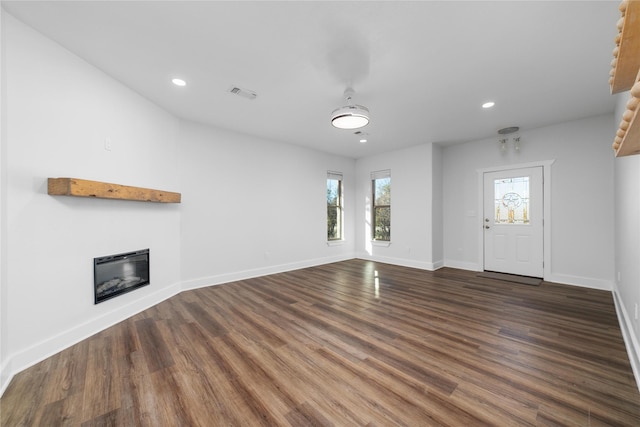 unfurnished living room with dark hardwood / wood-style flooring