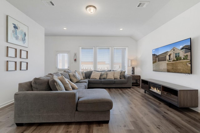 living room with dark hardwood / wood-style floors and vaulted ceiling