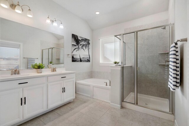 bathroom with tile patterned flooring, vanity, separate shower and tub, and lofted ceiling