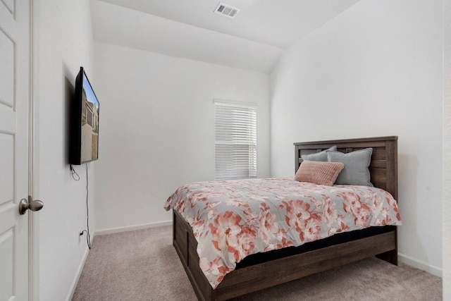 carpeted bedroom with vaulted ceiling