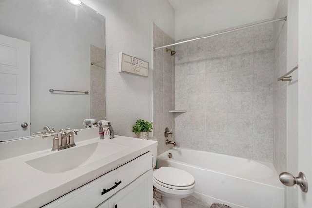 full bathroom with tiled shower / bath combo, toilet, and vanity