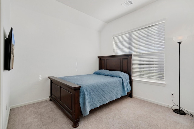 bedroom with light carpet and vaulted ceiling