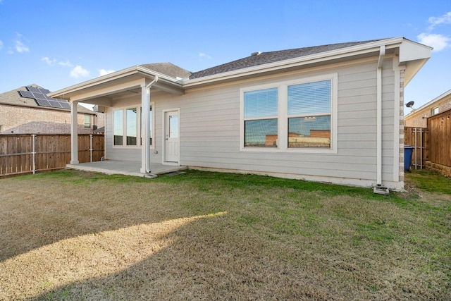 back of property featuring a yard and a patio