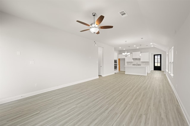 2009 Elm Pl, Northlake, TX 76247 - unfurnished living room featuring a chandelier, ceiling fan, light wood-style flooring, recessed lighting, and lofted ceiling