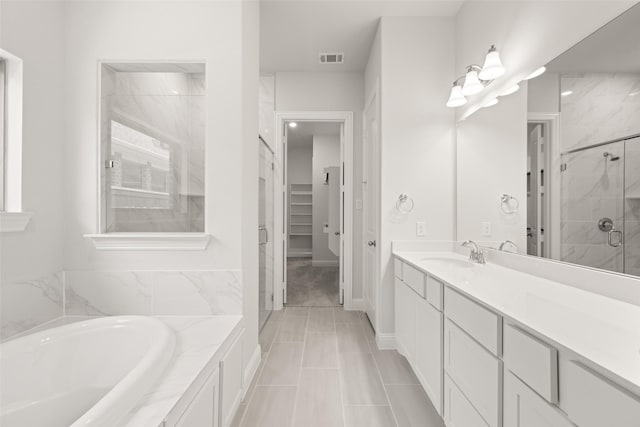 2009 Elm Pl, Northlake, TX 76247 - bathroom featuring a shower stall, a garden tub, vanity, and a walk in closet