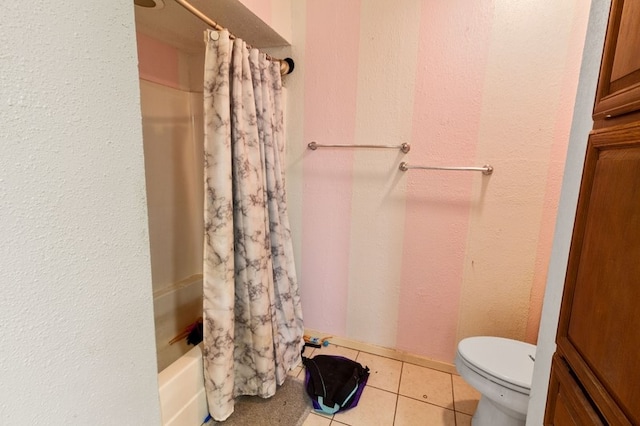 bathroom with tile patterned flooring, shower / bath combo, and toilet