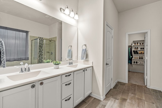 bathroom featuring vanity and a shower with shower door