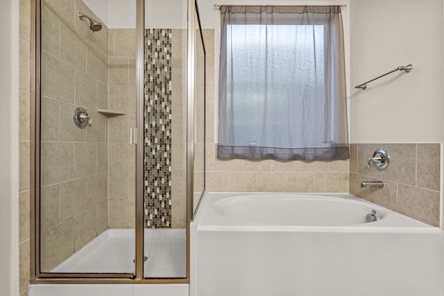 bathroom featuring separate shower and tub