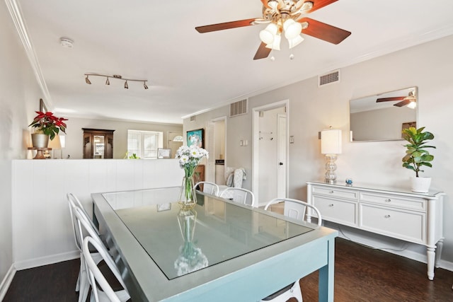 dining area with dark hardwood / wood-style flooring and ornamental molding