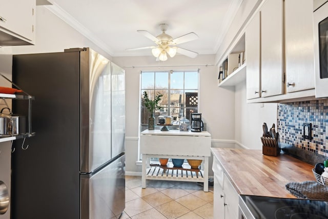 kitchen with white cabinets, stainless steel refrigerator with ice dispenser, ceiling fan, light tile patterned floors, and tasteful backsplash