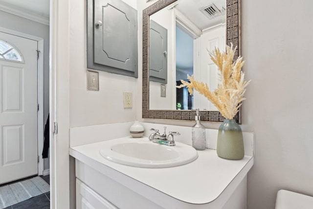 bathroom with vanity and crown molding