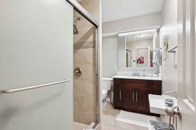 bathroom with tile patterned floors, vanity, toilet, and a shower with shower door