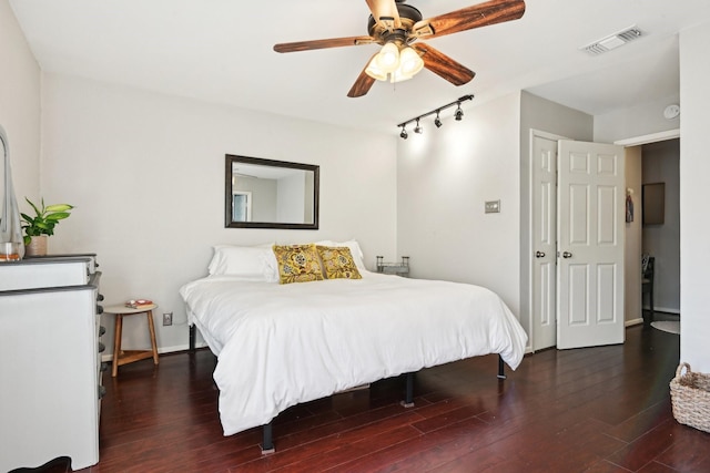 bedroom with dark hardwood / wood-style flooring, a closet, and ceiling fan