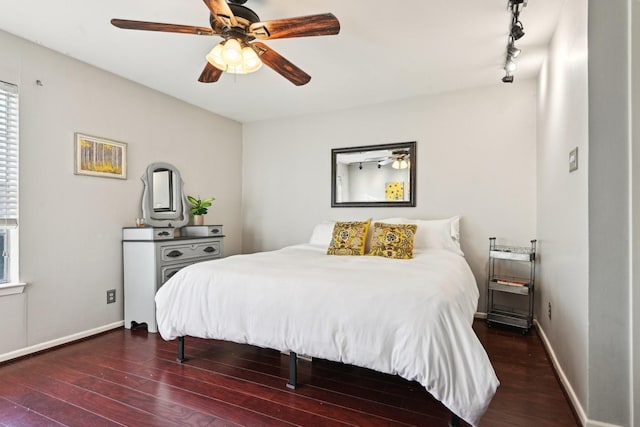 bedroom featuring ceiling fan, dark wood-type flooring, and track lighting